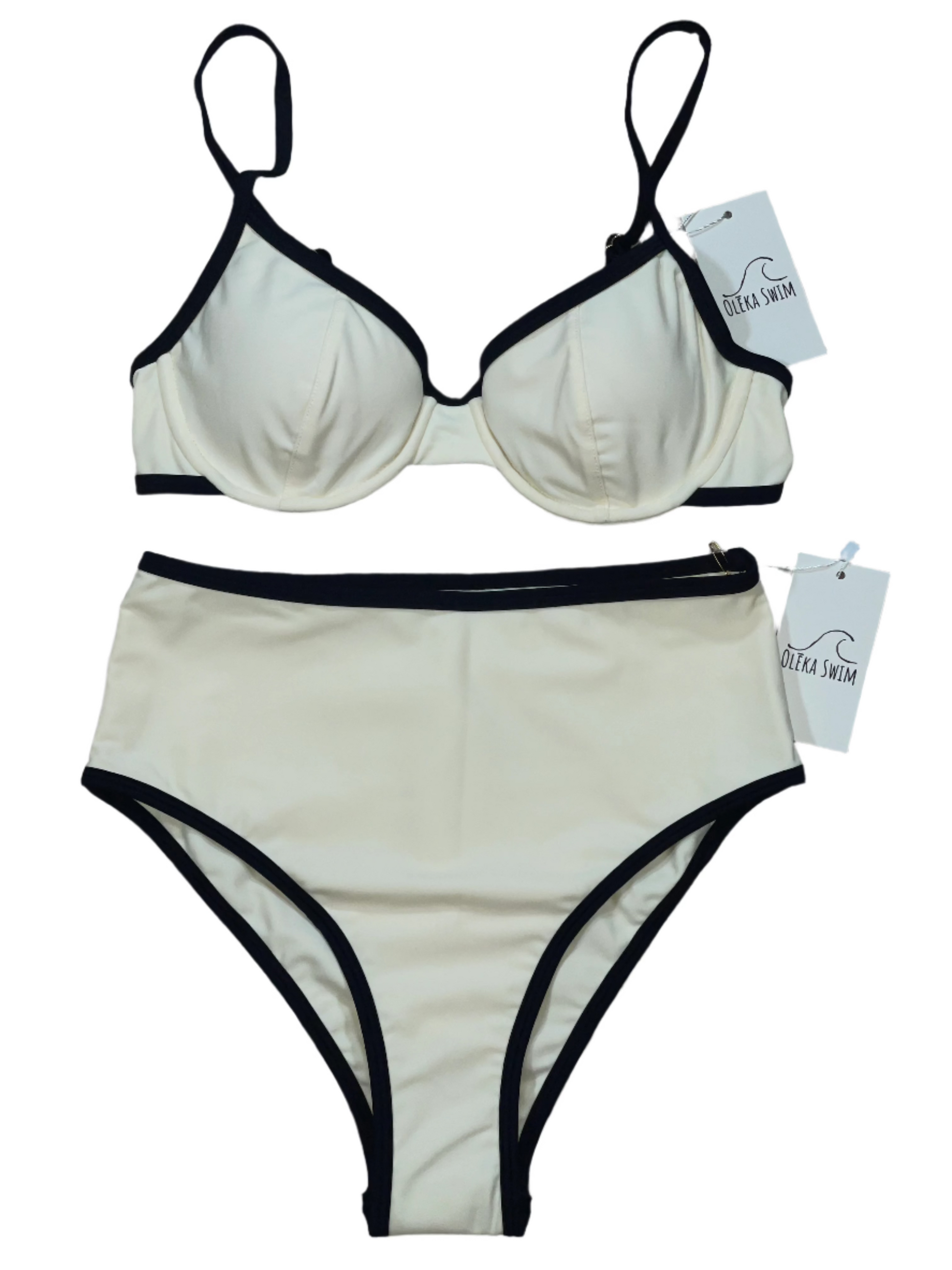 A cream-colored Kona bikini with black trim, featuring a high-waisted bottom and a supportive underwire top. The bikini is displayed flat on a white background with tags attached, labeled 'Oleka Swim.