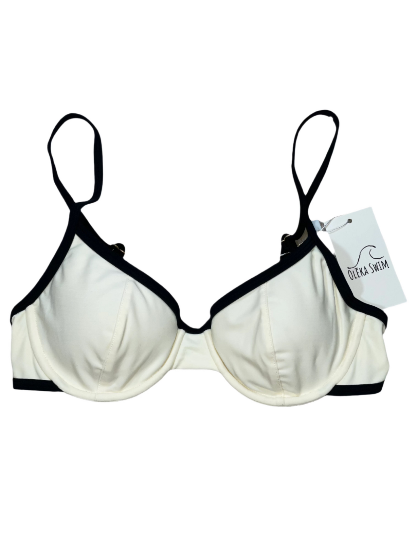 A cream-colored bikini top with black trim, featuring underwire cups and adjustable straps. The top is displayed flat on a white background with a tag attached, labeled 'Oleka Swim.